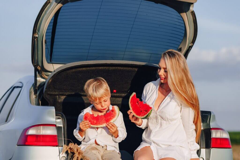 Mother and son eating watermelon