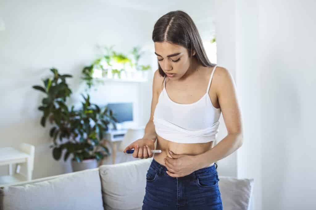 Women using weight loss pen