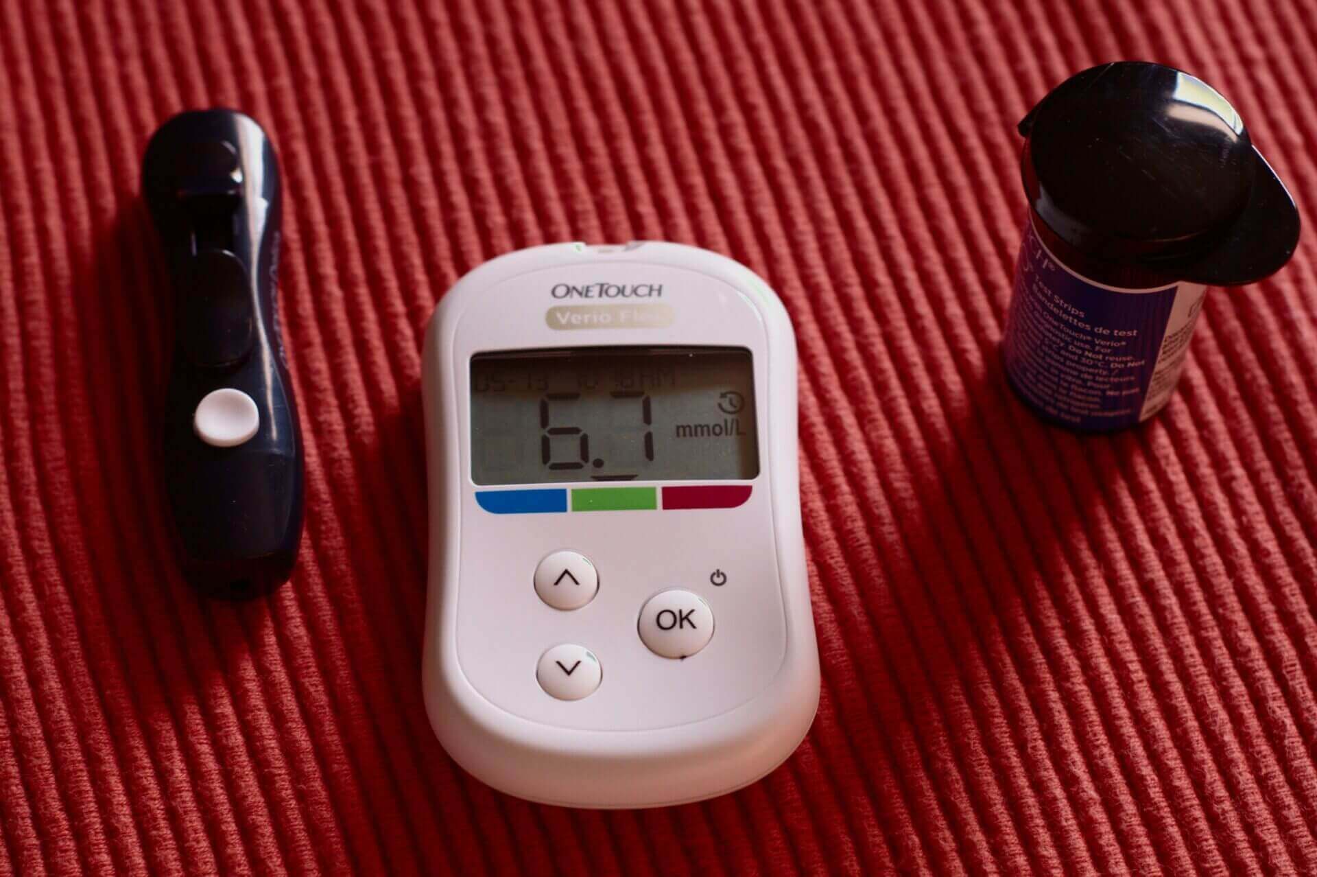 Glucose meter on the red background